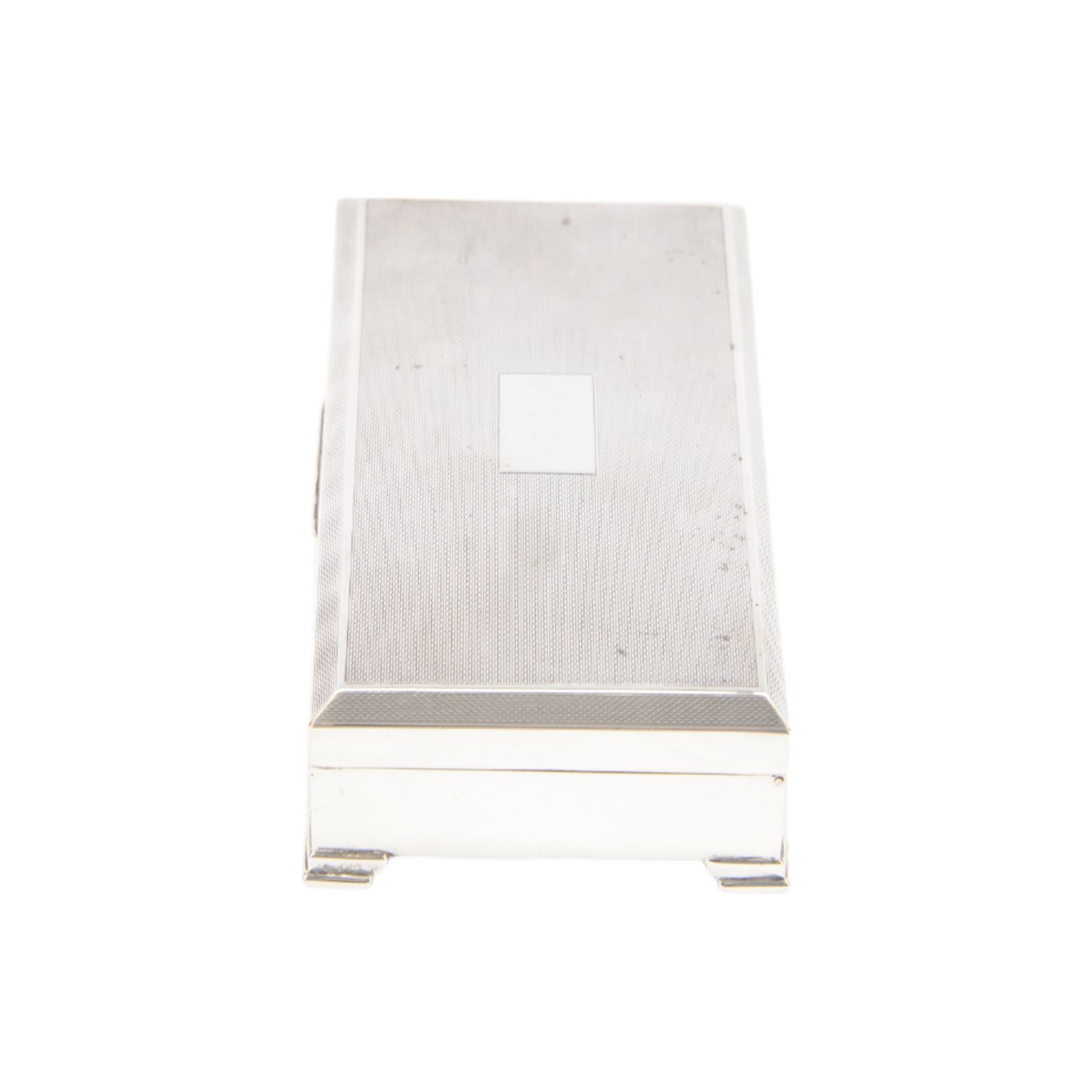 Mid 20th century silver mounted cigarette box, of rectangular form with engine turned decoration to the hinged cover, with vacant rectangular cartouche, opening to reveal a compartmentalised softwood interior, upon four bracket feet, hallmarked Henry Clifford Davis, Birmingham 1964, H4cm, W15cm
