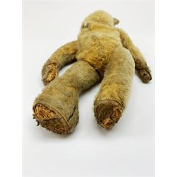 Early 20th century American mohair teddy bear c1920 with wood wool filled body humped back body with jointed limbs, black boot button eyes and horizontal stitched nose and mouth H12