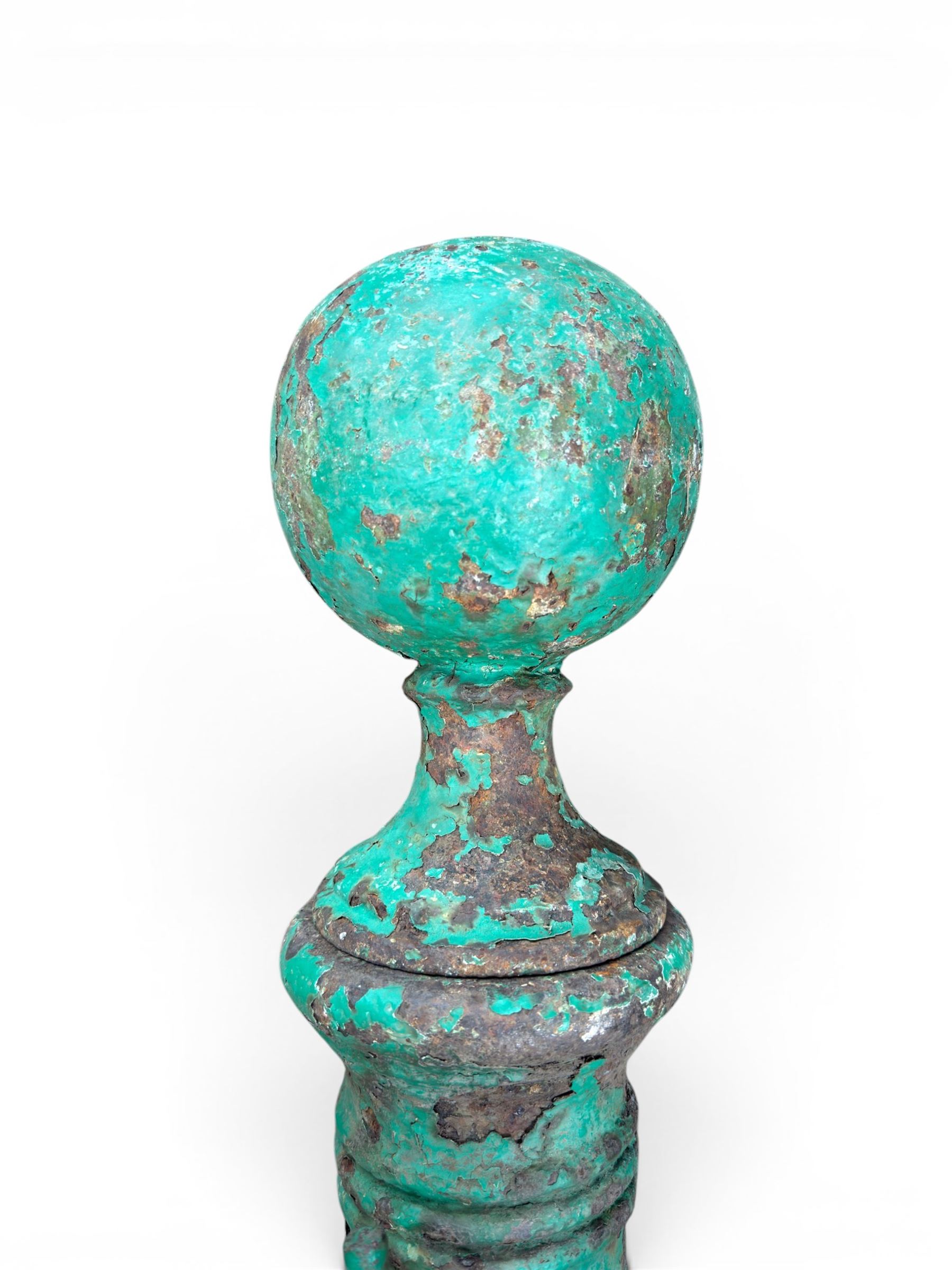 19th century circular cast iron gate post with finial, painted in distressed green finish