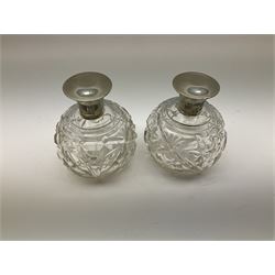 Pair of silver collared and lidded perfume bottles of bulbous form together with a pair of silver collared scent bottle of conical form, all hallmarked but worn and indistinct, tallest example H17cm 