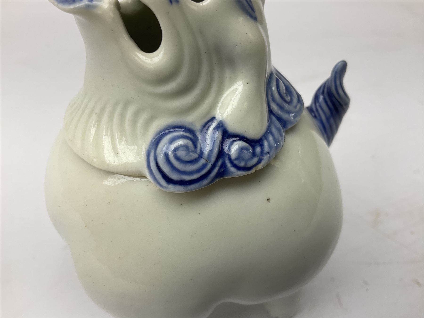 Japanese Hirado blue and white porcelain censer in the form of a Lion Dog, together with a Hirado porcelain shell shaped dish, centrally decorated with an exotic bird flanked by two roundels on floral scroll ground, censer H13cm
