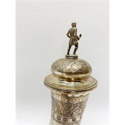 Late 19th century Danish silver drinking horn and cover, the body with hexagonal and beaded finial, raised upon two talon feet and further scroll foot, chased with scrolling foliate and zoomorphic bands, the detachable domed cover with conforming decoration surmounted by a figure holding a hammer, the cover interior impressed with maker's mark (partly worn and indistinct), alongside Danish Three Towers mark for 1881, with the Assay Master mark for Simon Groth (1863-1904), H23.5cm, weight 14.75 ozt (459 grams)

