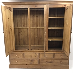 Large pine three door combination wardrobe, projecting cornice, three doors, single mirror above four short and two long drawers, plinth base, W206cm, H212cm, D62xm  