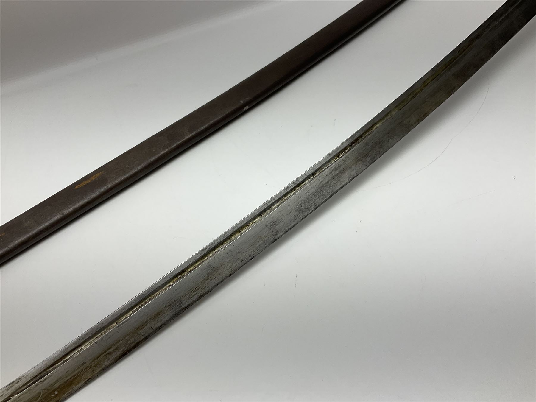 19th Century German (Saxony) Cavalry Sword, the 90.5cm single edge curved steel blade with narrow fuller to the back edge at each side, engraved with a crowned AR monogram and coat of arms, stamped with crowned AR, the back edge engraved C.v Keller im Solingen 1862, the brass half basket hilt with three flat curved bars, applied badge missing, marked G.R. 4, with ribbed leather covered grip and leather finger strap; in steel scabbard with two fixed suspension rings to one side and stamped G.R. II 118; L109.5cm overall