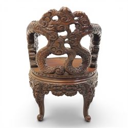 Chinese carved hardwood dragon throne chair, the shaped and pierced back with entwined dragons and cloud motifs, sweeping dragon-form arms terminating in carved heads, solid panel seat over foliate carved apron, on four mask carved cabriole supports
