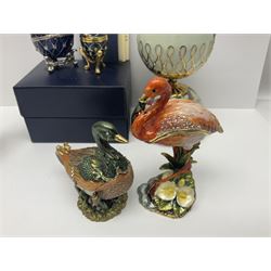 Romanoff Collection enamel egg, decorated with blue guilloche enamel set with paste stones, upon a gilded stand, in original box, together with a collection of similar novelty enamel trinket boxes, mostly modelled as animals, and two Heirloom Porcelain musical eggs, tallest H16cm