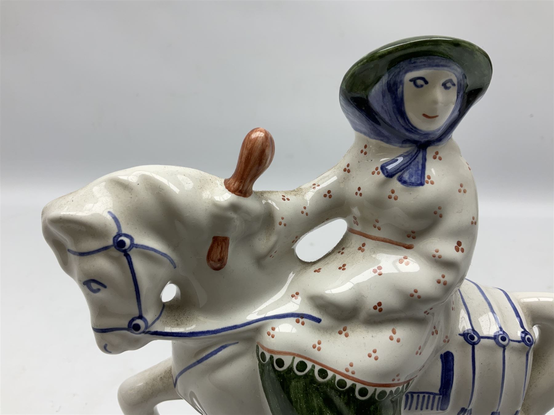 Rye pottery figure modelled as a lady upon a horse, with printed marks beneath, H19cm
