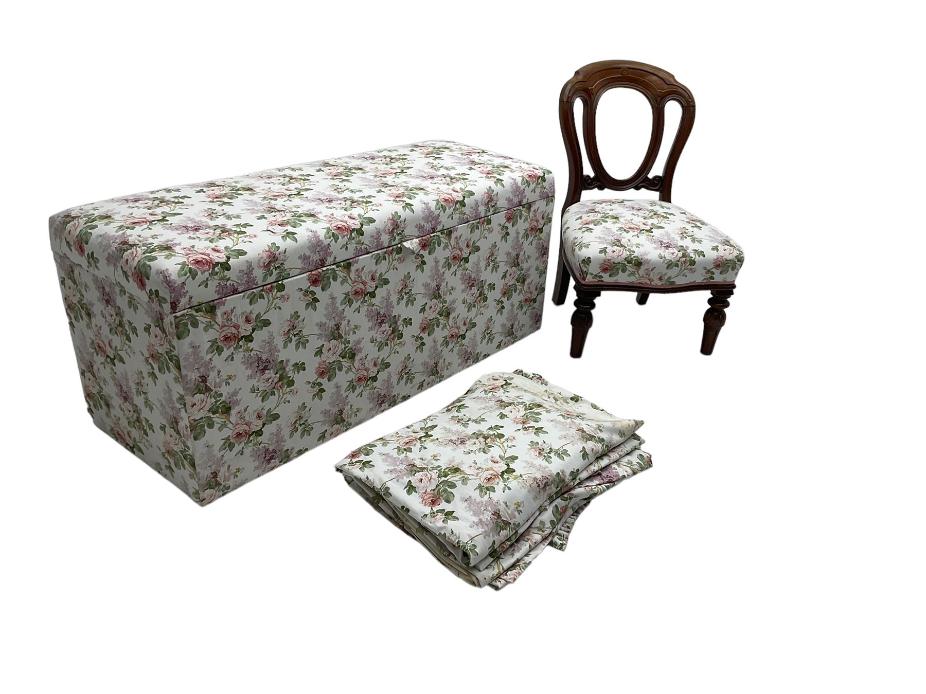 Ottoman blanket box upholstered in floral pattern fabric, matching bedroom chair and curtains