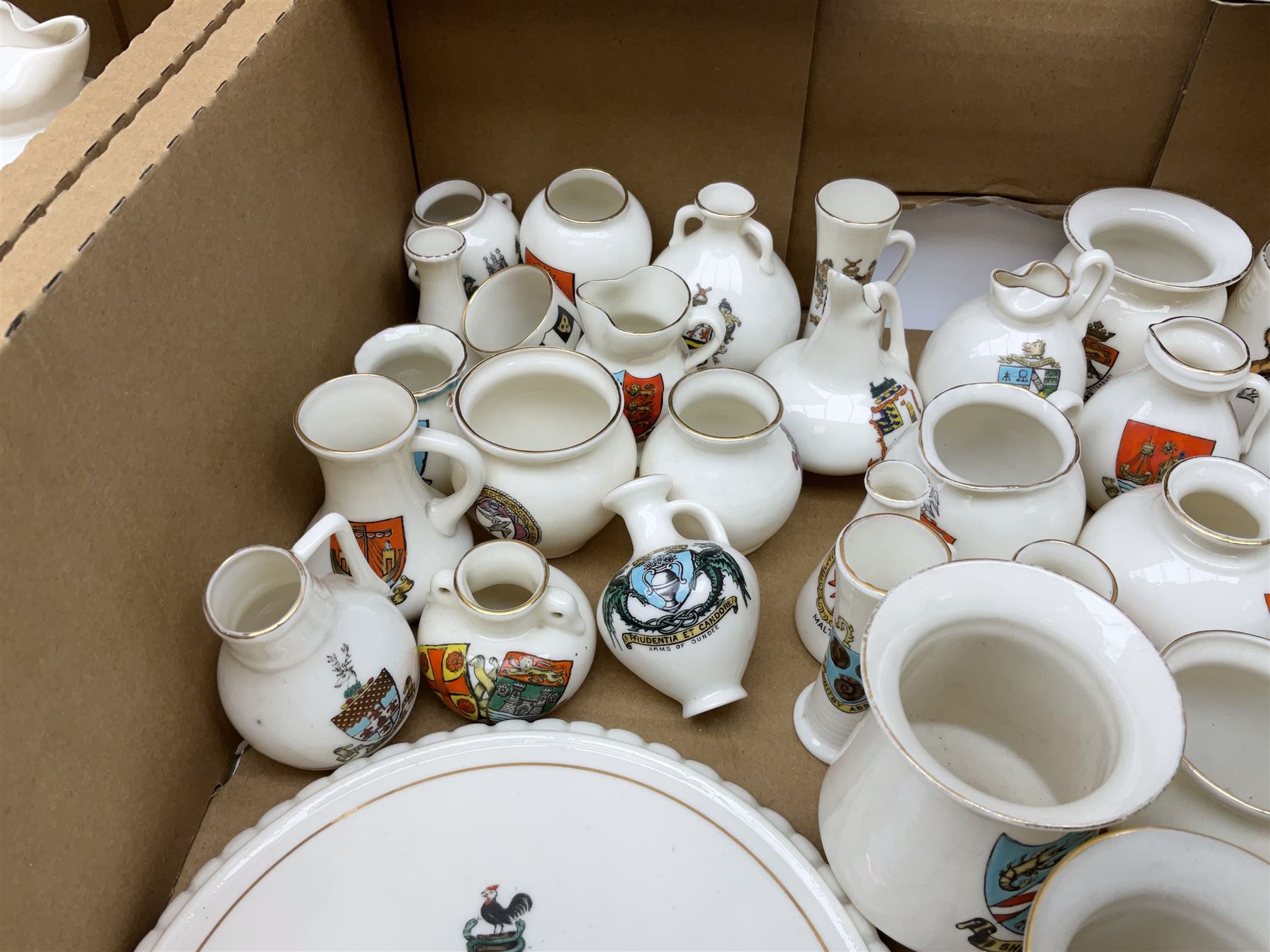 Collection of W H Goss crested ware, to include Yorkshire Roman Ewer, Scarborough ancient jug, salt and pepper shakers, Norwegian horse shaped beer bowl, The Old Horse Shoe, etc, together with five Shelley examples modelled as piano, boat, heart shaped box, etc, in two boxes 