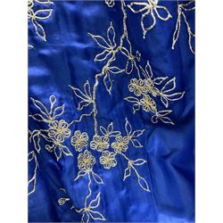 Chinese silk jacket, embroidered with floral sprigs on a deep blue ground, together with a Japanese silk kimono, embroidered with a gold peacock amongst flowers on a blue ground, a kangaroo fur purse and an ocelot fur evening bag