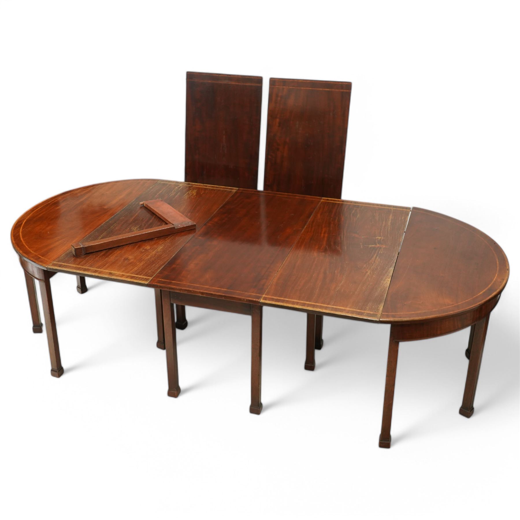 19th century and later mahogany extending dining table (12' 7’'), two D-ends, central drop-leaf table and two additional leaves, with satinwood bands, on square supports with block feet (lacking forks)