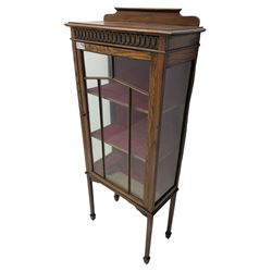 Early 20th century oak display cabinet, single astragal glazed door enclosing two shelves, square tapering supports on spade feet