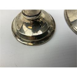 1920's silver mounted capstan inkwell, hallmarked Charles Boyton & Son Ltd, London 1929, together with an early 20th century silver mounted dwarf candlestick, hallmarked A J Pepper & Co, Birmingham 1918