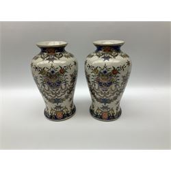 Pair ceramic urns and covers with gilded finials, decorated with cherubs and floral imagery, a pair of cream vases with blue detail and floral decoration, along with a pair of oriental urns and covers with a gilt metal base