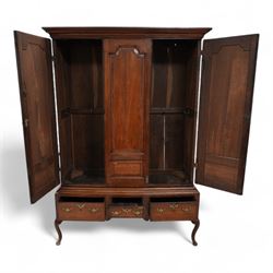 Georgian oak livery cupboard, projecting cornice over panelled front with mahogany bandings, enclosed by two doors, the base fitted with three drawers over shaped apron and cabriole supports 