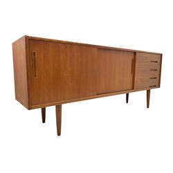 Nils Jonsson - mid-20th century teak sideboard, rectangular top over three-section base, left and centre sections with sliding double doors enclosing shelving, right section with four drawers, raised on tapered supports