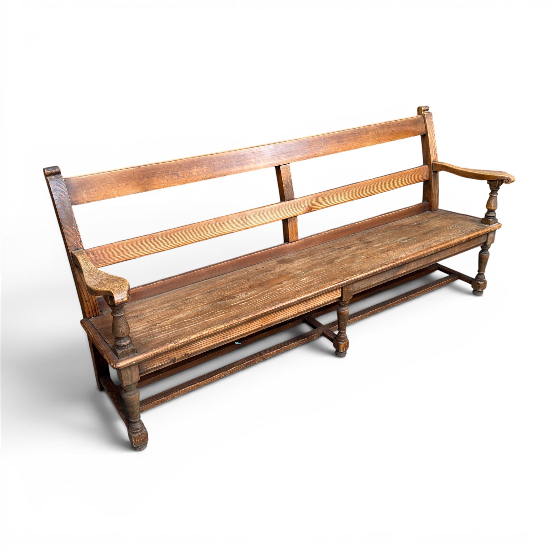 Early 20th century pine and oak bench seat, stained pine rail back frame with shaped oak arms