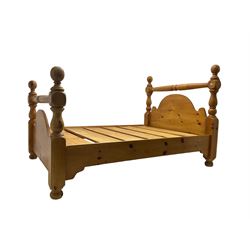 Traditional waxed pine 4’ 6” double bedstead, turned headboard cresting rail and shaped back with baluster uprights