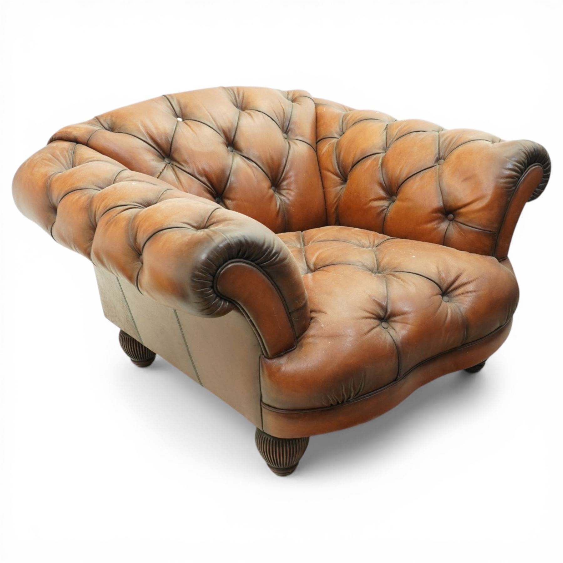 Tetrad England - large armchair upholstered in buttoned leather, with stool