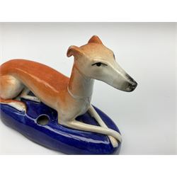 Pair of Staffordshire recumbent greyhound pen holders 