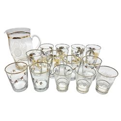 Mid 20th century glass part lemonade set comprisimg jug decorated with white floral sprays and gilt banding with three matching cups, together with a set of six tumblers decorated in black and gilt with flowers and set of four other glasses