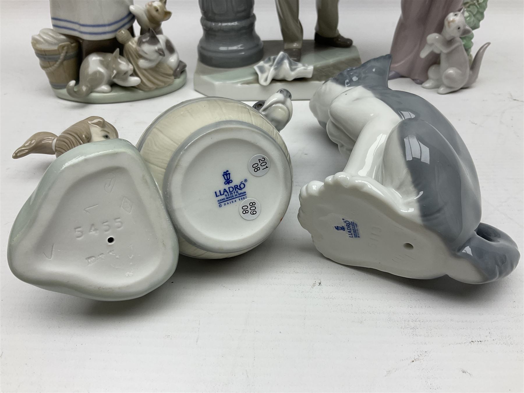 Five Lladro figures, including The Lamp Lighter no 5205,  Girl and Kittens no 6102, Cat no 5113 etc