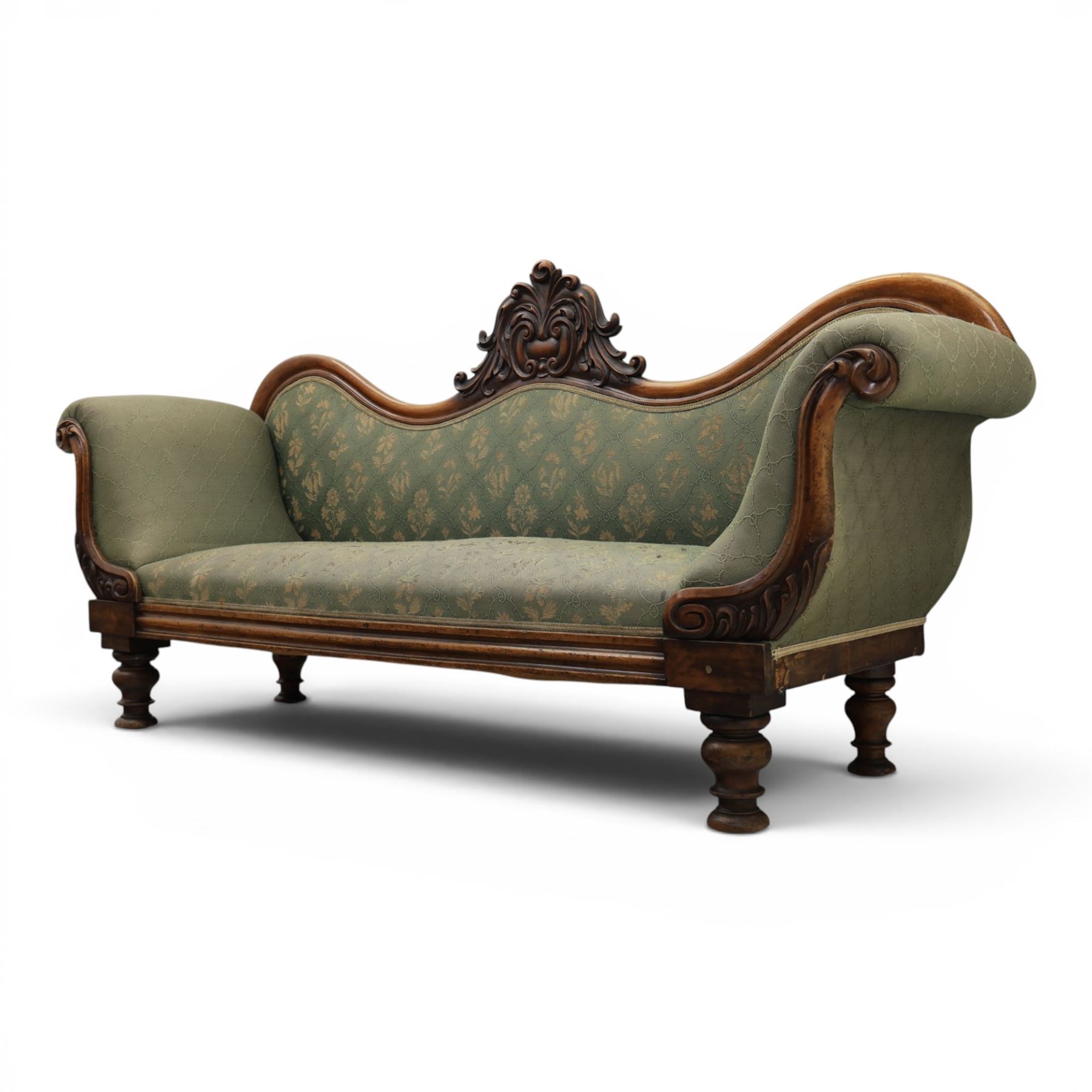 Victorian mahogany framed sofa, scroll arms with double camel back, green geometric upholstery, raised on turned supports