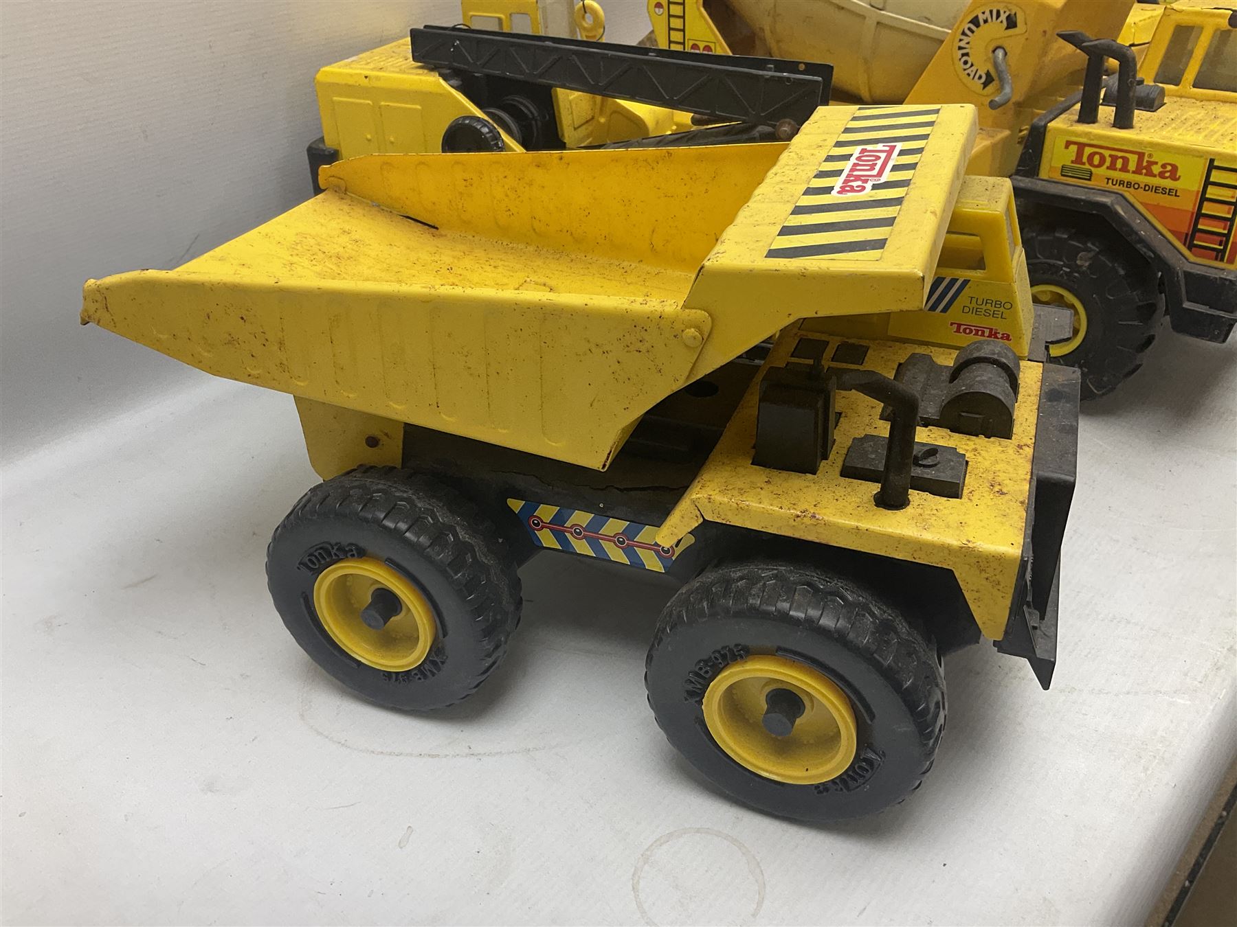 Tonka - five large scale pressed steel vehicles comprising Cement Mixer, Mobile Crane, Bulldozer and two Dumper Trucks (5)
