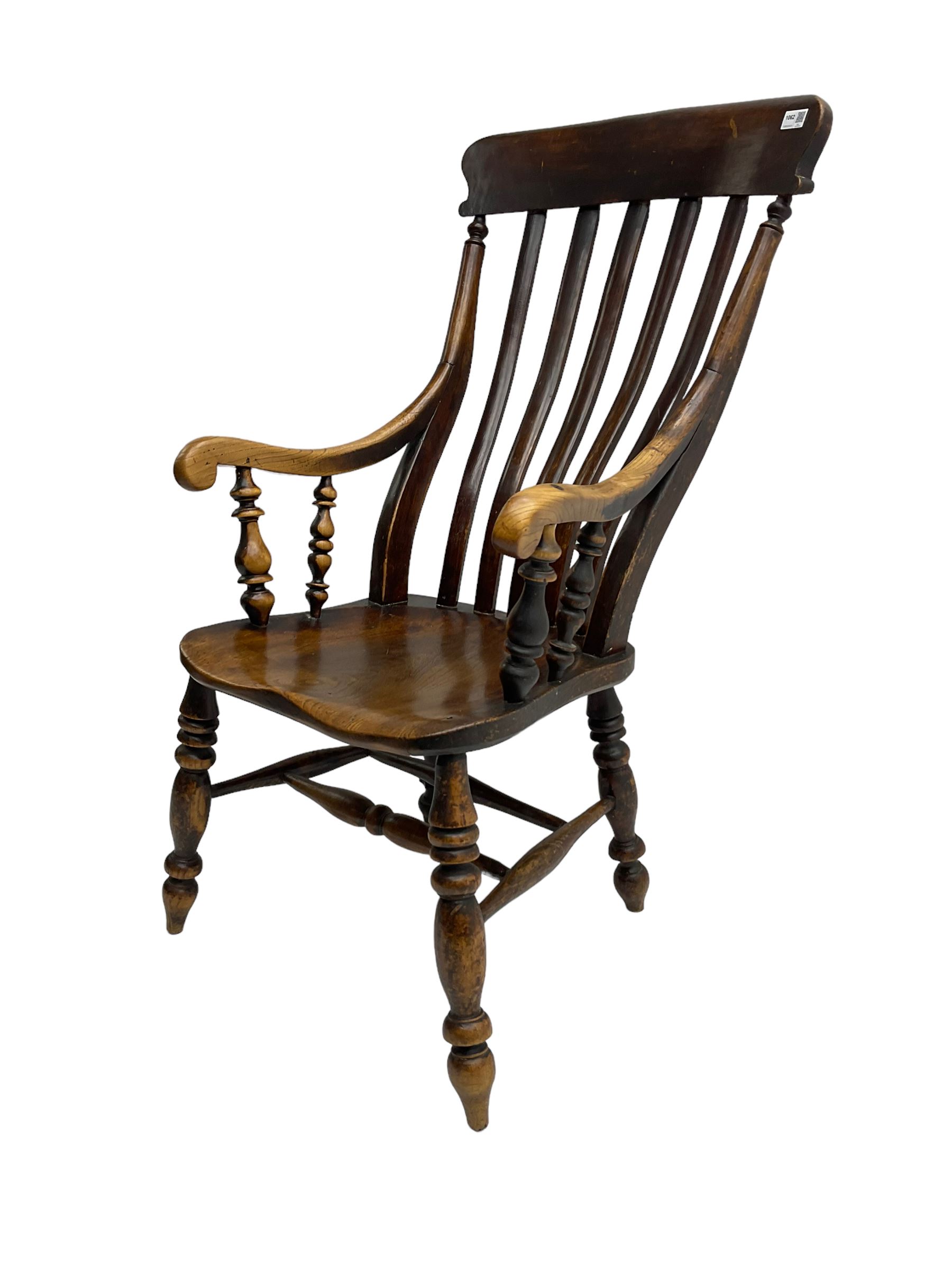 Late 19th century elm farmhouse armchair, high lath back raised on turned supports united by stretcher