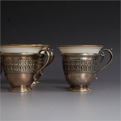 Set of six Lenox porcelain coffee cups, with gilt rims, each with American silver openwork cup holders, stamped sterling
