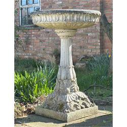 Reconstituted stone garden bird bath, the circular top with moulded waterleaf design on a ...