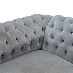 Early 20th century Chesterfield drop-arm two-seat settee, traditional shape with rolled arms and back, upholstered in buttoned pale blue fabric, on ogee block feet with brass castors 