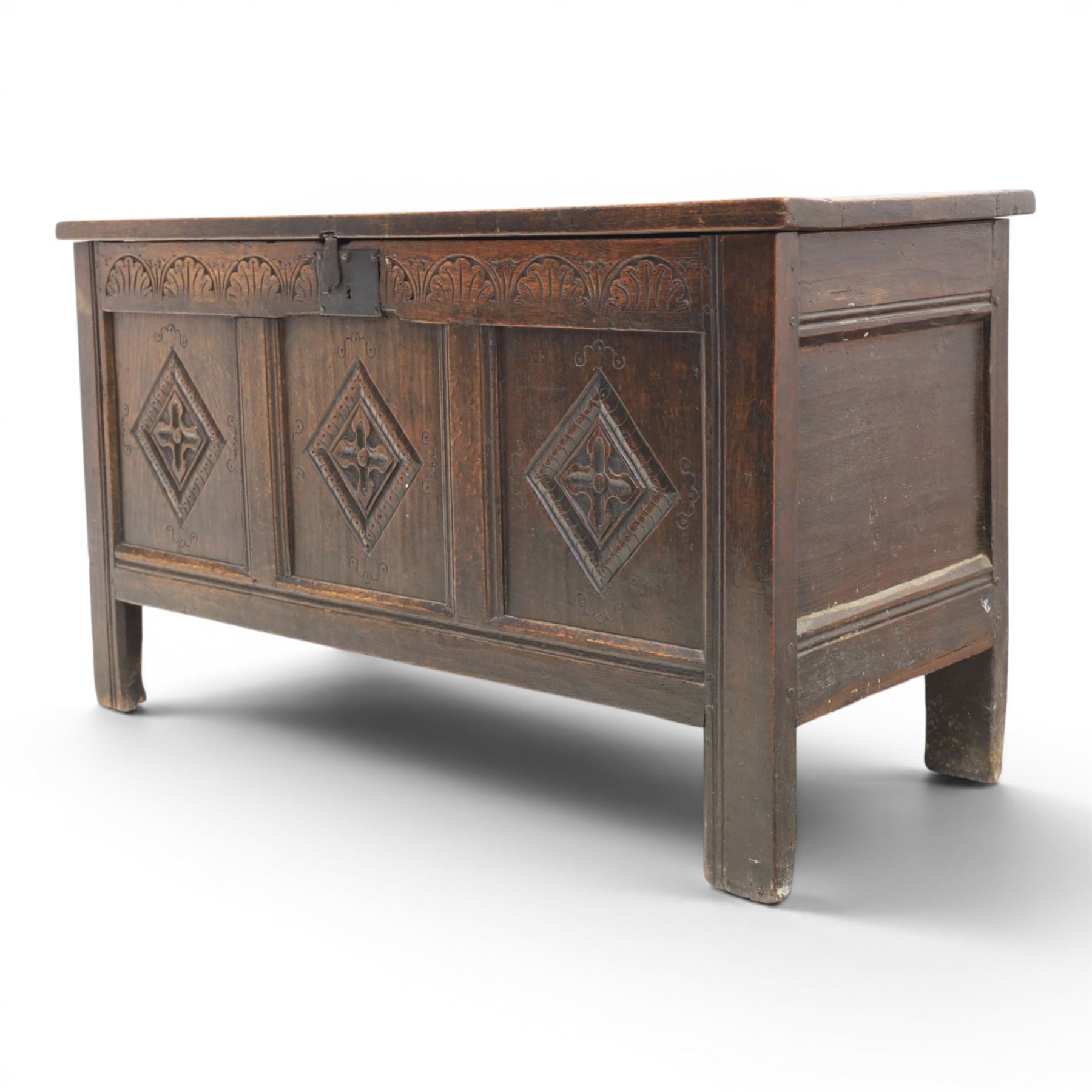 18th century style oak coffer, panelled rectangular top hinged to reveal storage with candle box, carved frieze and front panels, raised on stile feet