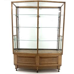 Harris & Sheldon Ltd of Manchester, Art Deco oak shop display cabinet, shaped front with two fielded panels, internal parquetry base, adjustable glass shelves on iron up stands, sliding glass doors three 