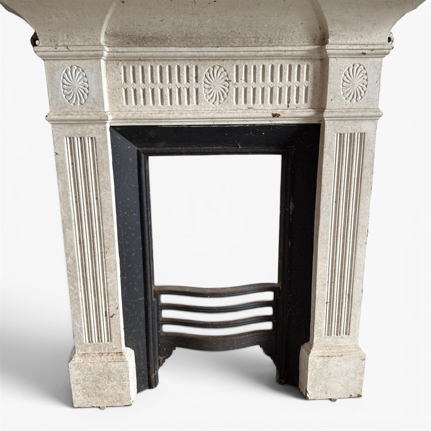 19th century Neoclassical design cast iron bedroom fire surround with fluted and rosette design, white painted finish with  black slip