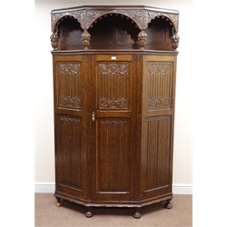  Large early 20th century carved oak hall wardrobe with shaped front, heavily carved, cup and cover supports, single panelled door, bun feet, W123cm, H201cm, D48cm  