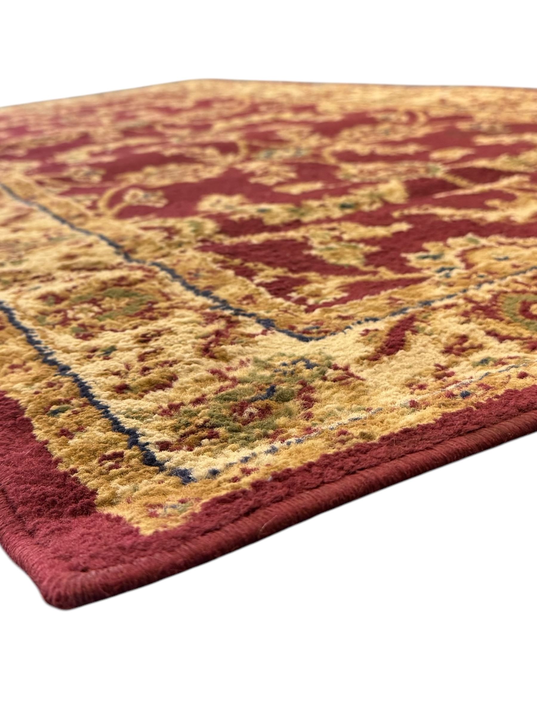 Contemporary Dunelm 'Legacy' ground rug, the field decorated with symmetrical scrolling foliate and floral motifs, bordered by an ivory band with repeating floral designs interspersed with leafy branches, inner guard stripe with fine linear patterning