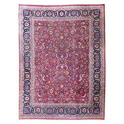 Persian Mashad design wool carpet, the red ground with dense scrolling floral and foliate ...