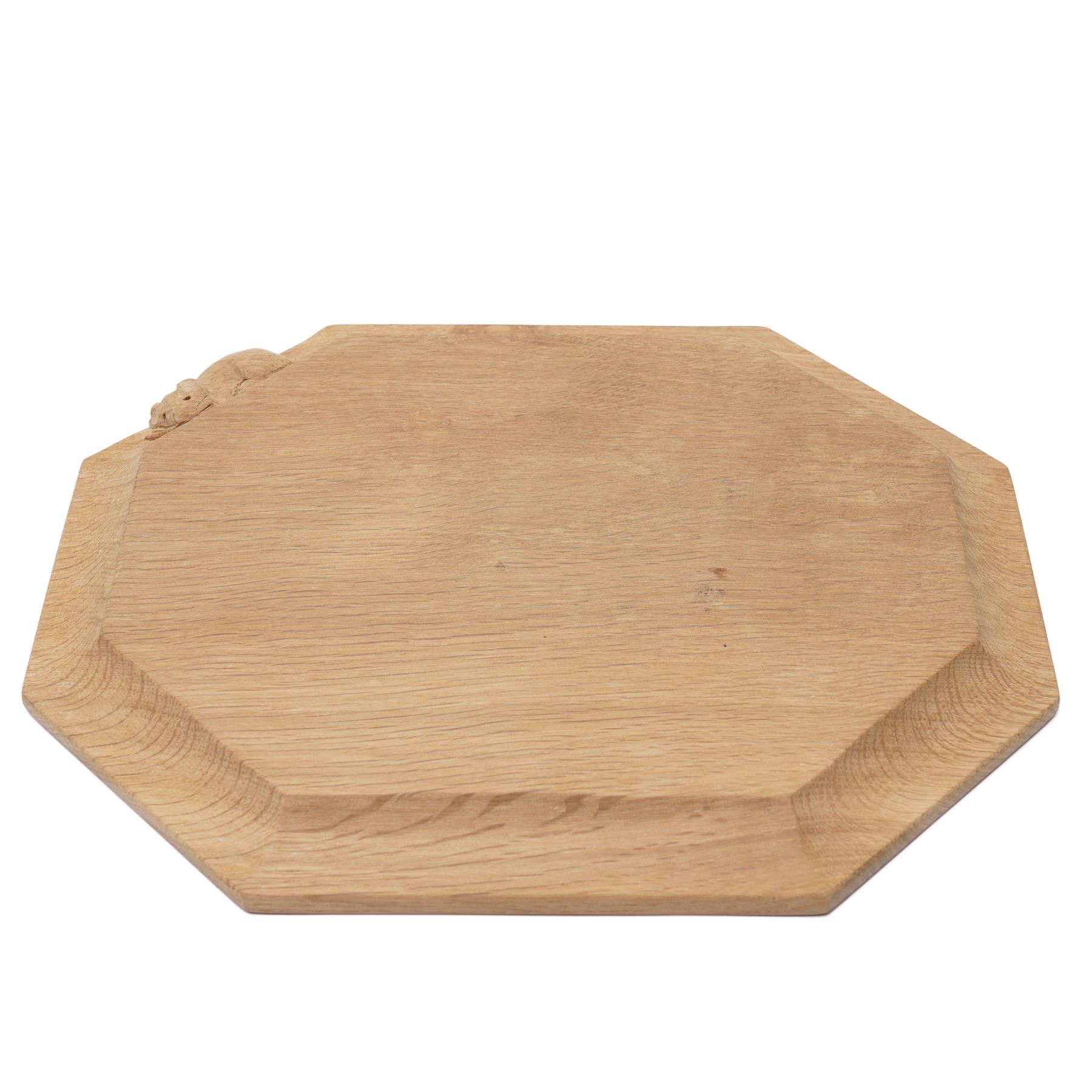Mouseman - adzed oak bread board of canted rectangular design with carved mouse signature W30cm by the workshop of Robert Thompson, Kilburn