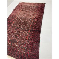 Persian red ground rug with repeating lozenge design 