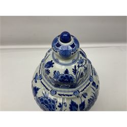 De Porceleyne Fles Delftware blue and white covered jar, of fluted baluster form, with floral and insect decoration, upon an octagonal foot, the octagonal cover with urn shaped finial, H32cm