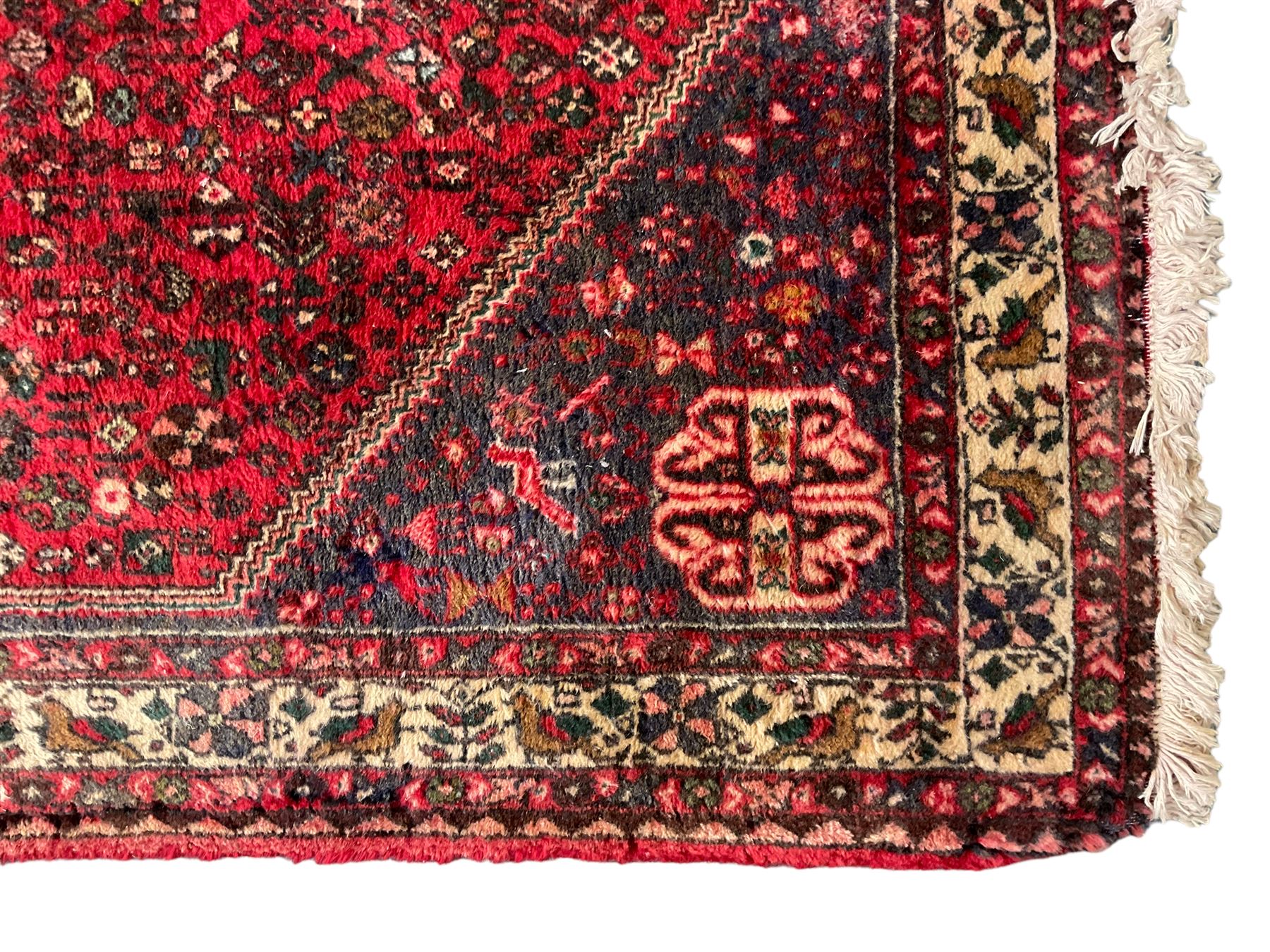 Persian Kashan crimson ground rug, hexagonal field decorated with central medallion and surrounding bird plant and animal motifs, guarded border with repeating floral and bird design