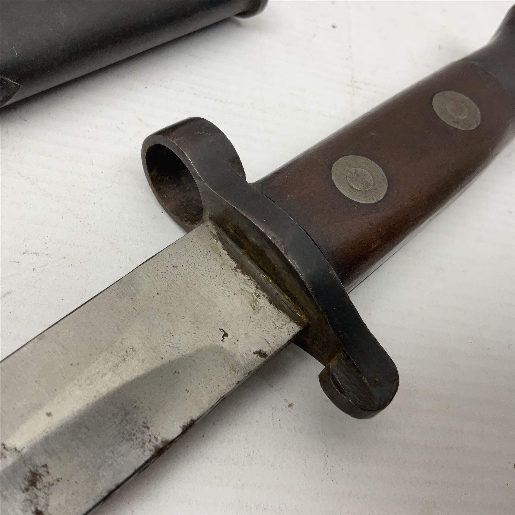 British Pattern 1888 knife bayonet, the 30.5cm double edged blade with raised central medial ridge; in leather covered scabbard L40.5cm overall