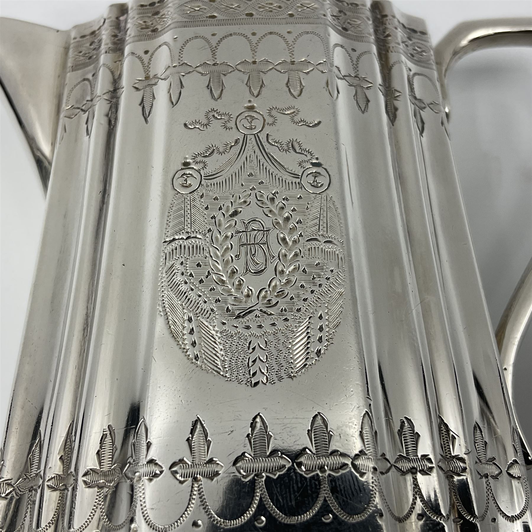 Victorian three-piece silver tea service, comprising teapot, twin handled open sucrier and milk jug, of oval form with shaped rim and C handles, each engraved with crests and bands of strapwork decoration, the milk jug and sucrier with gilt interiors, hallmarked Josiah Williams & Co, Exeter 1881, the teapot with ivory insulators and finial, all contained with a tooled leather, blue silk and velvet lined fitted case, retailed by West & Sun, Dublin 
This item has been registered for sale under Section 10 of the APHA Ivory Act