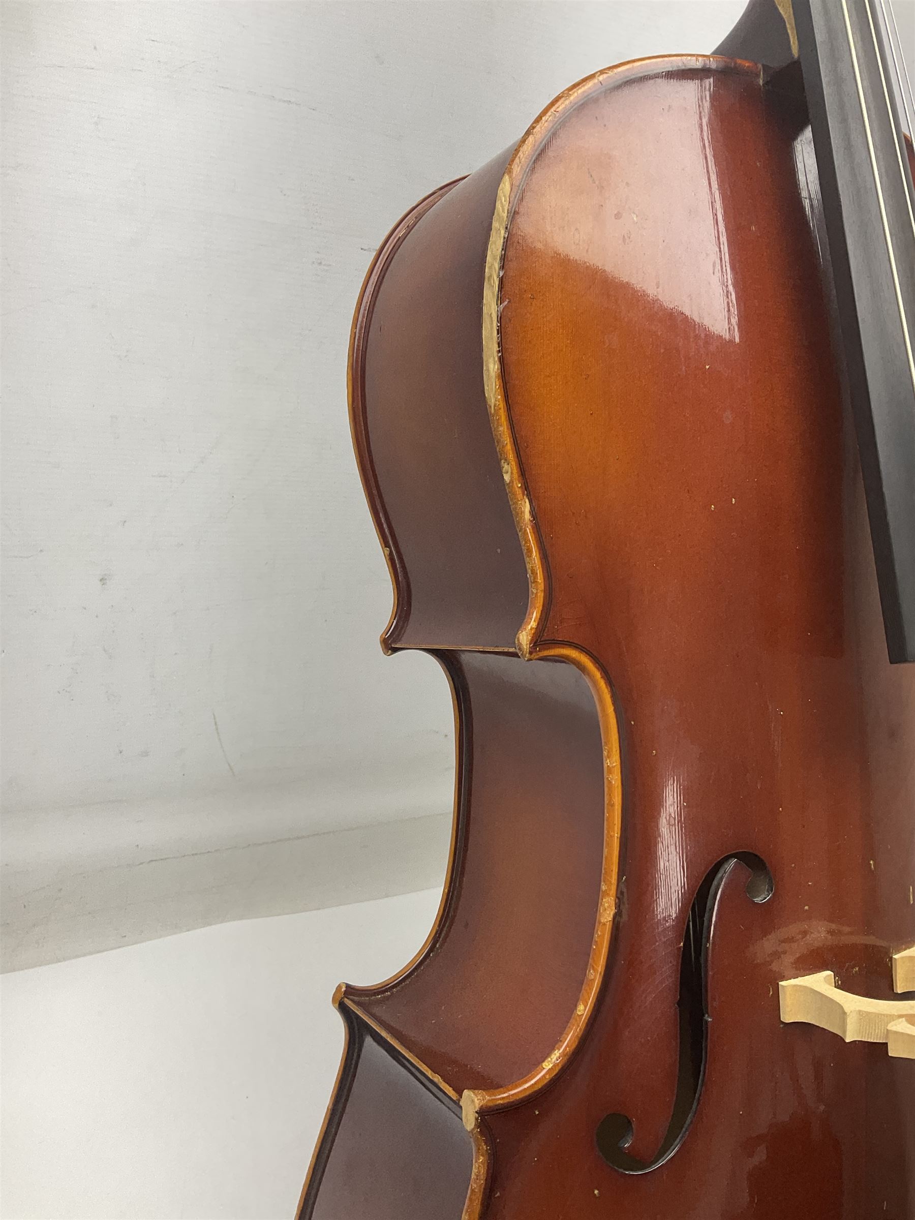 Two student half-size cellos - Boosey & Hawkes Artia with 65cm one-piece back and spruce top; bears maker's label; L104cm overall; and Romanian with 65.5cm two-piece maple back and ribs and spruce top; bears label; L108.5cm overall; each in soft carrying case with two bows (2)