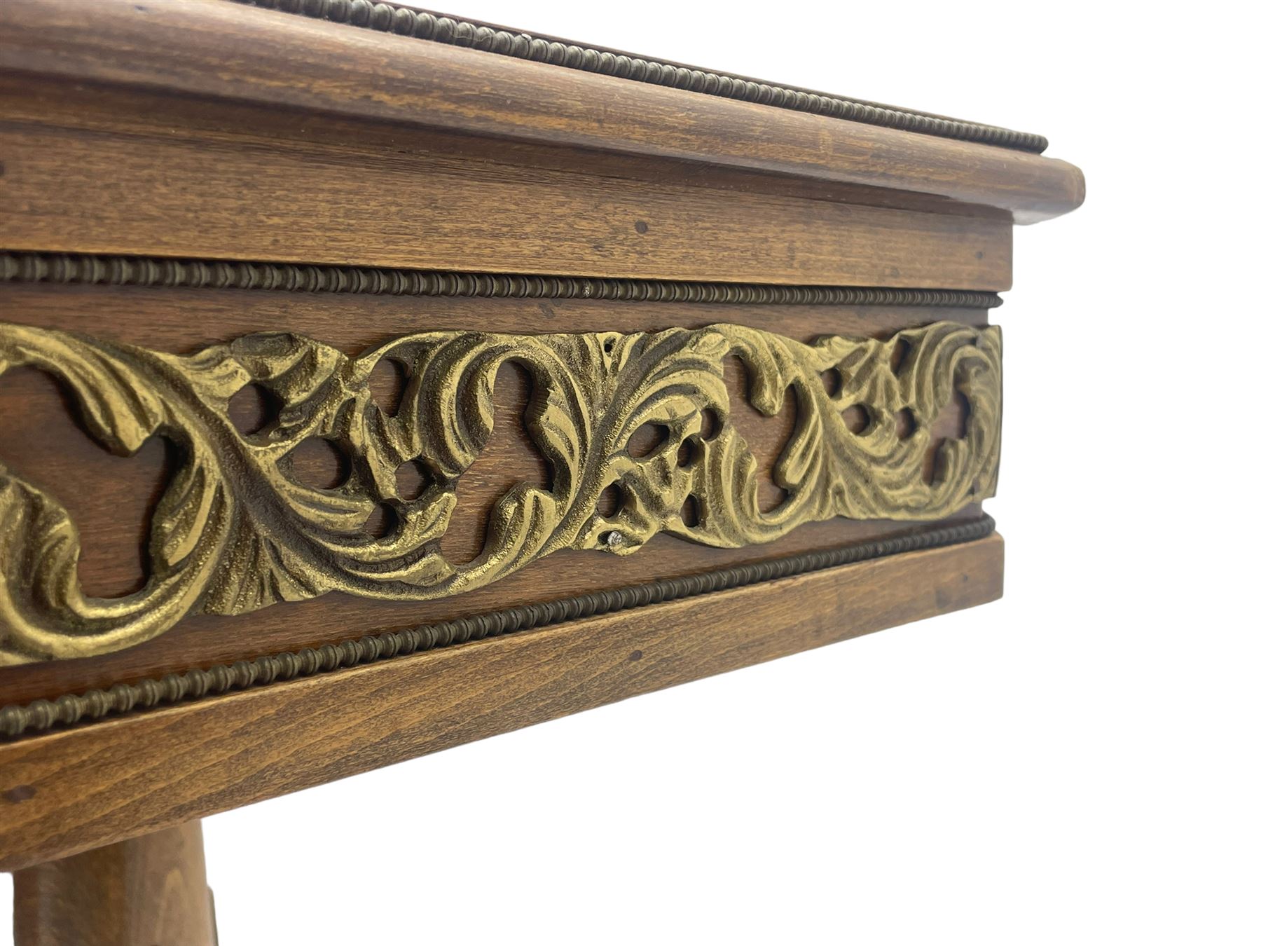 Mid-20th century figured walnut Italian design centre table, octagonal quarter veneered top with cross banding and moulded edge, the skirt decorated with scrolling foliage gilt metal mounts, on turned pedestal mounted with gilt acanthus leaves, quadruple splayed supports with further acanthus leaf decoration