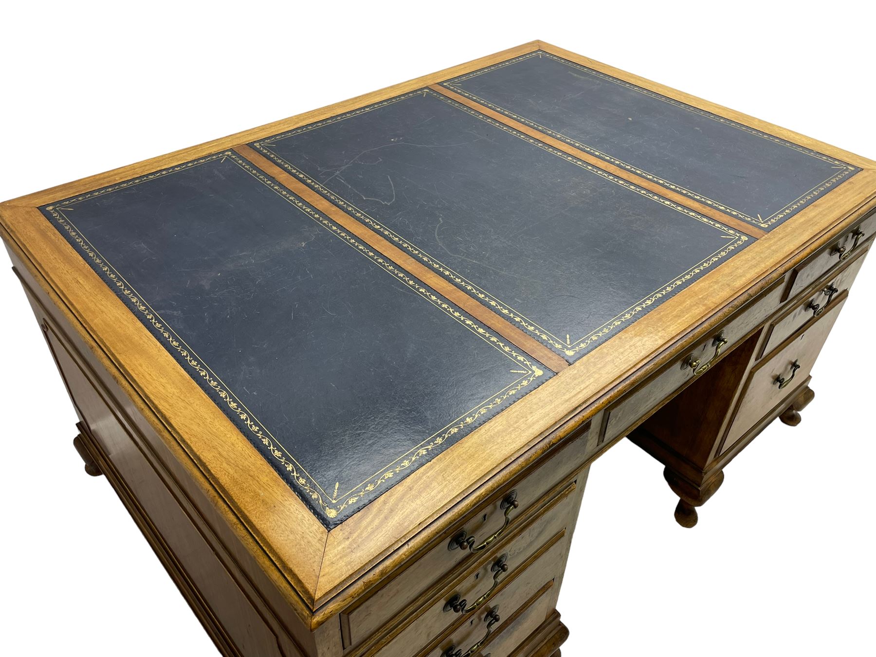 Early 20th century mahogany twin pedestal desk, the moulded rectangular top with three sectional leather insets with gilt decoration, fitted with eight drawers, on cabriole feet