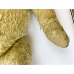 Chad Valley large teddy bear c1930s with wood wool filled blond mohair body, jointed swivel head with glass eyes, shaved muzzle with vertically stitched nose and mouth and jointed limbs H21