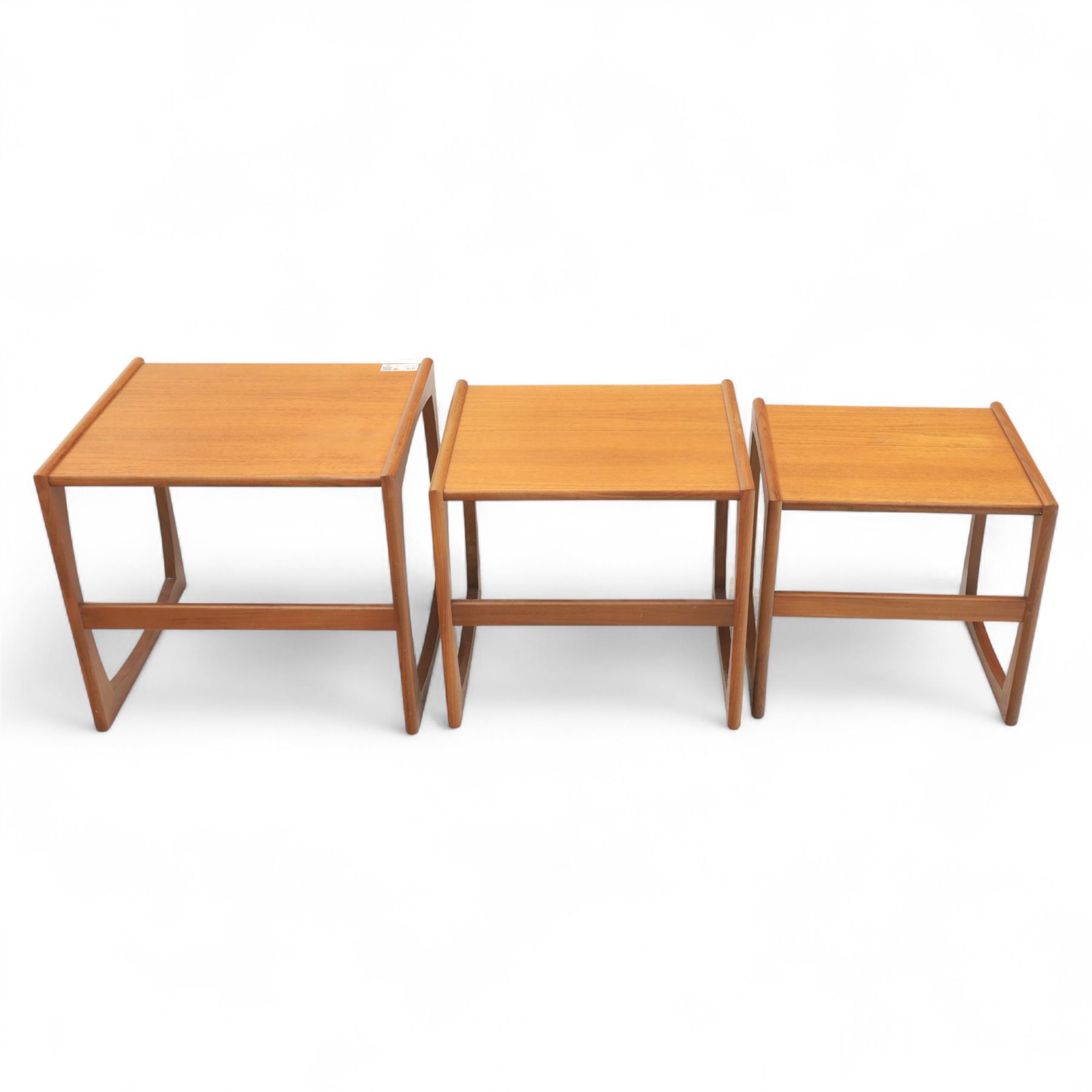 G-Plan - mid 20th century nest of three teak tables, rectangular tops with rounded edges, supported by sculptural open sided frames