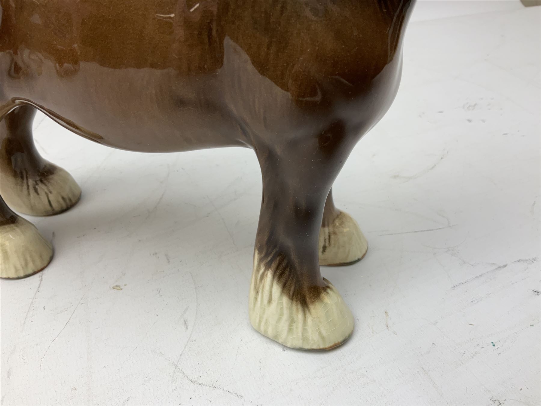 Three Beswick models comprising Hereford Bull no 949, 'CH Cutmil Cupie' Pug, and bay Shire horse, all with printed marks beneath